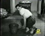 A maid in rubber apron washing the floor